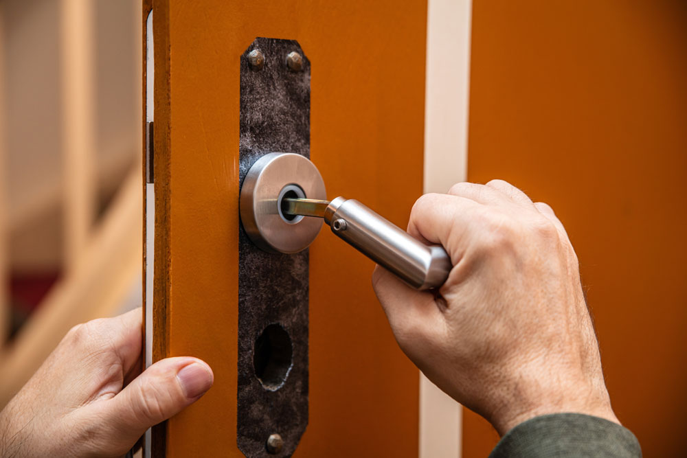 Locksmith rekeying a door lock in Houston TX